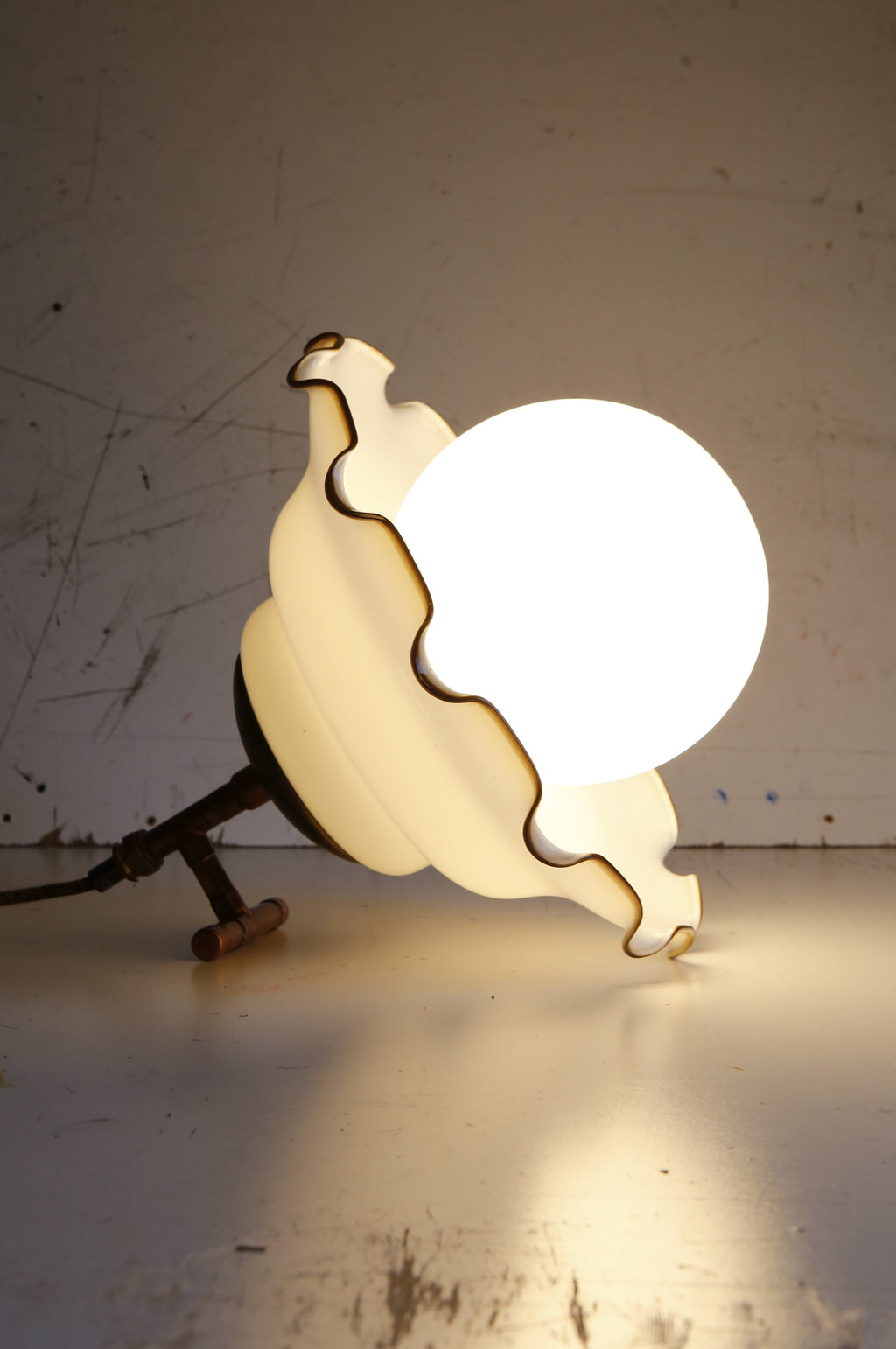 Decorative lamp with a unique design on a plain background