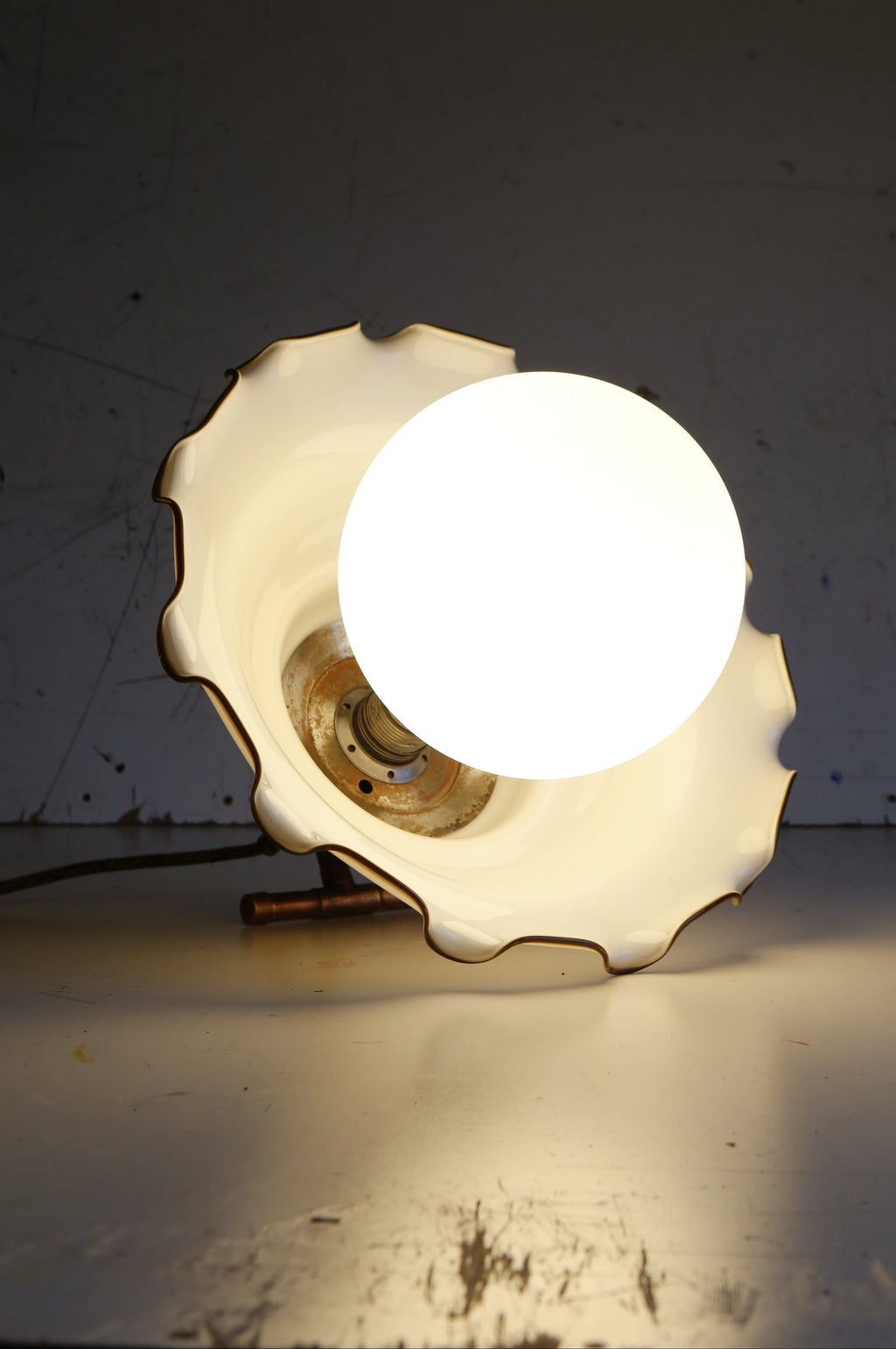 large porcelain Light bulb in a decorative holder on a plain background