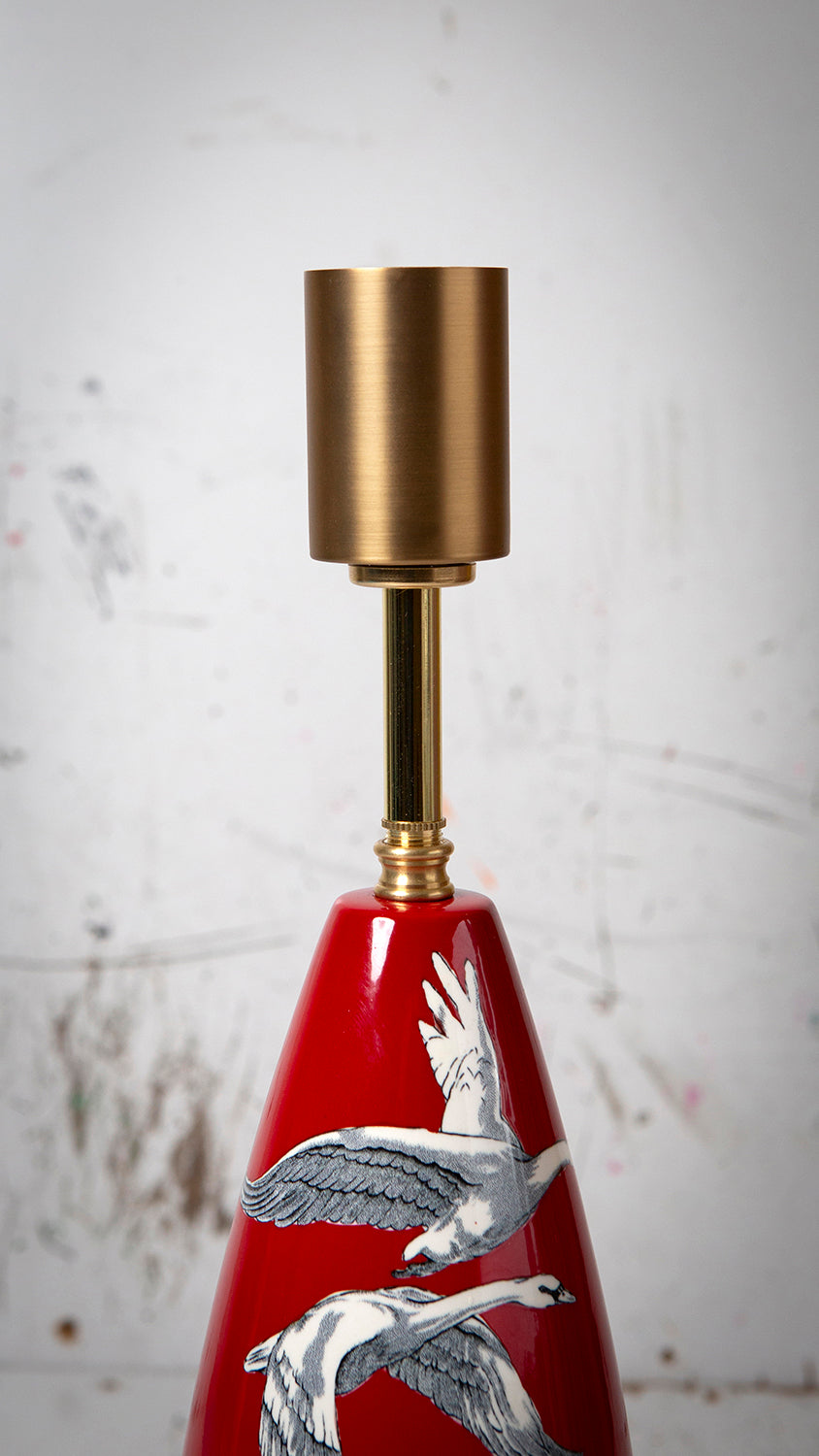 Original Crown Devon table lamp with red ceramic base featuring flying swans and gold accents.