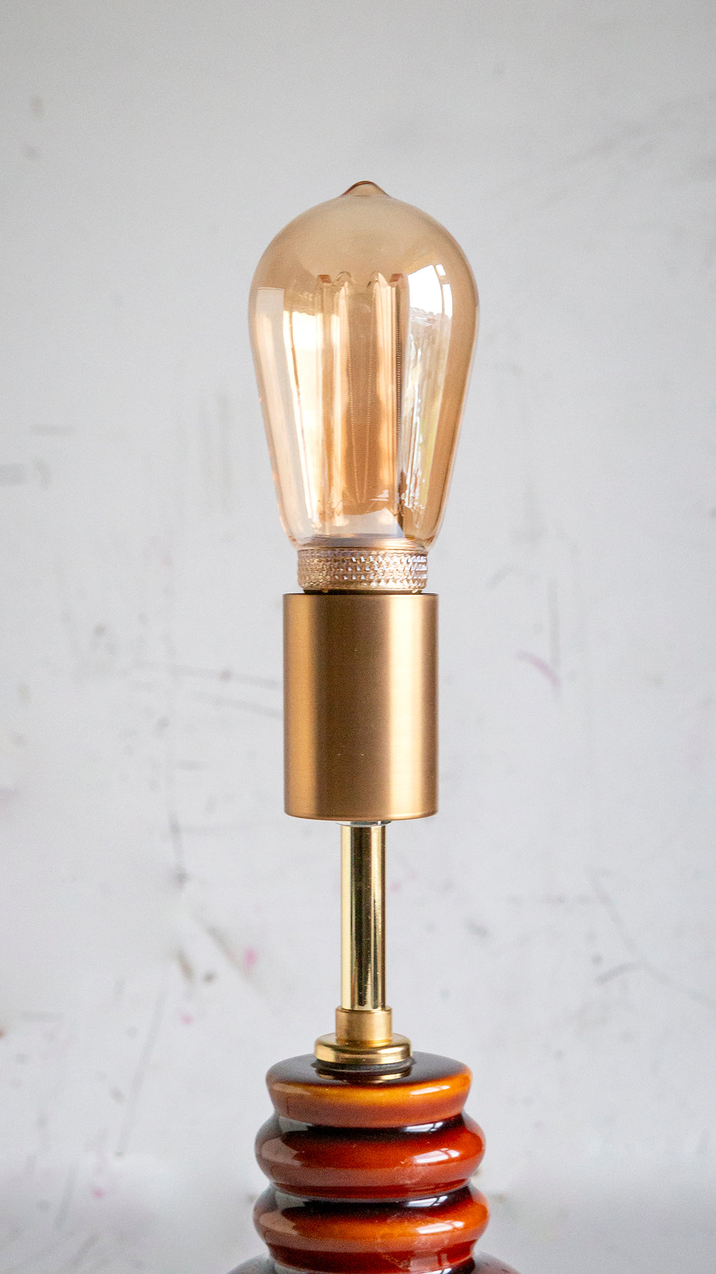 Decorative lamp with a vintage-style bulb on a light gray background