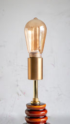 Decorative lamp with a vintage-style bulb on a light gray background