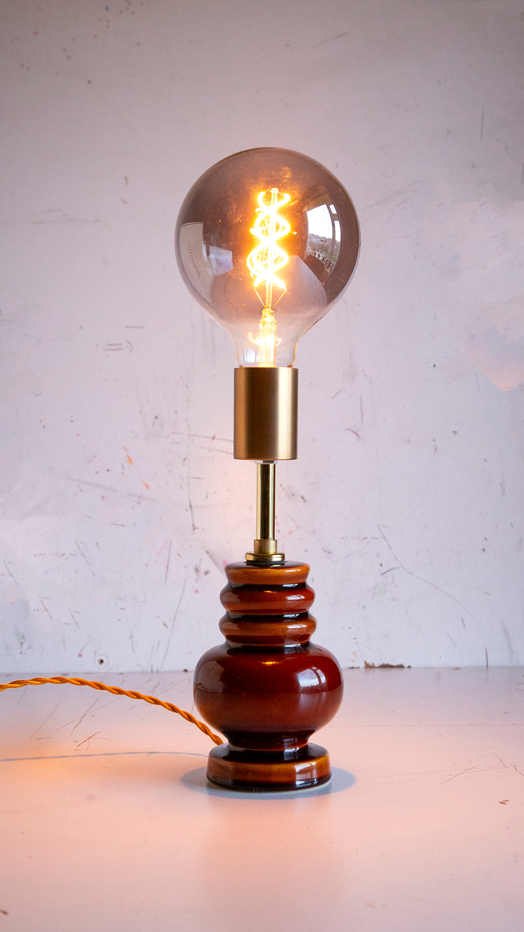 Vintage-style table lamp with a large light bulb on a white background