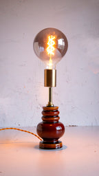 Vintage-style table lamp with a large light bulb on a white background