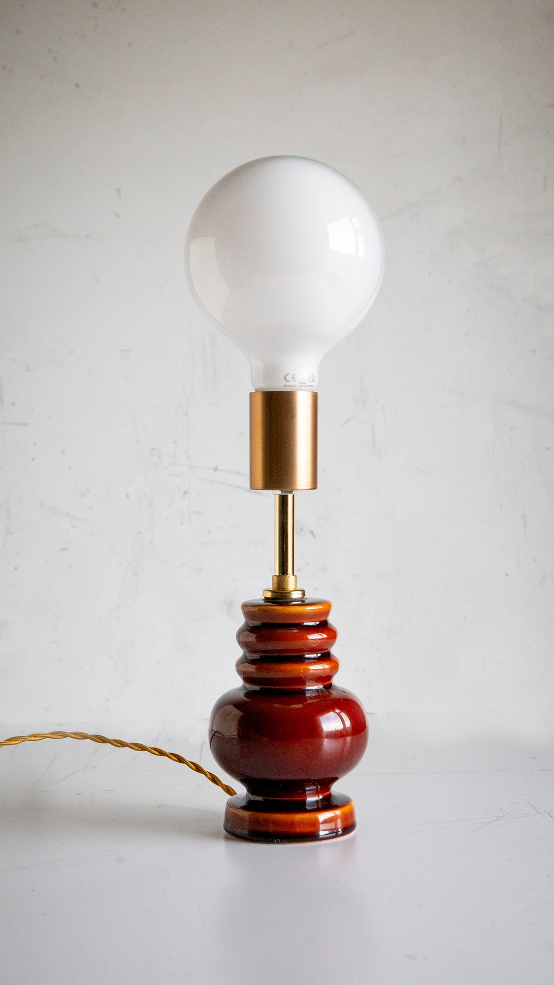 Small table lamp with a white bulb on a plain background
