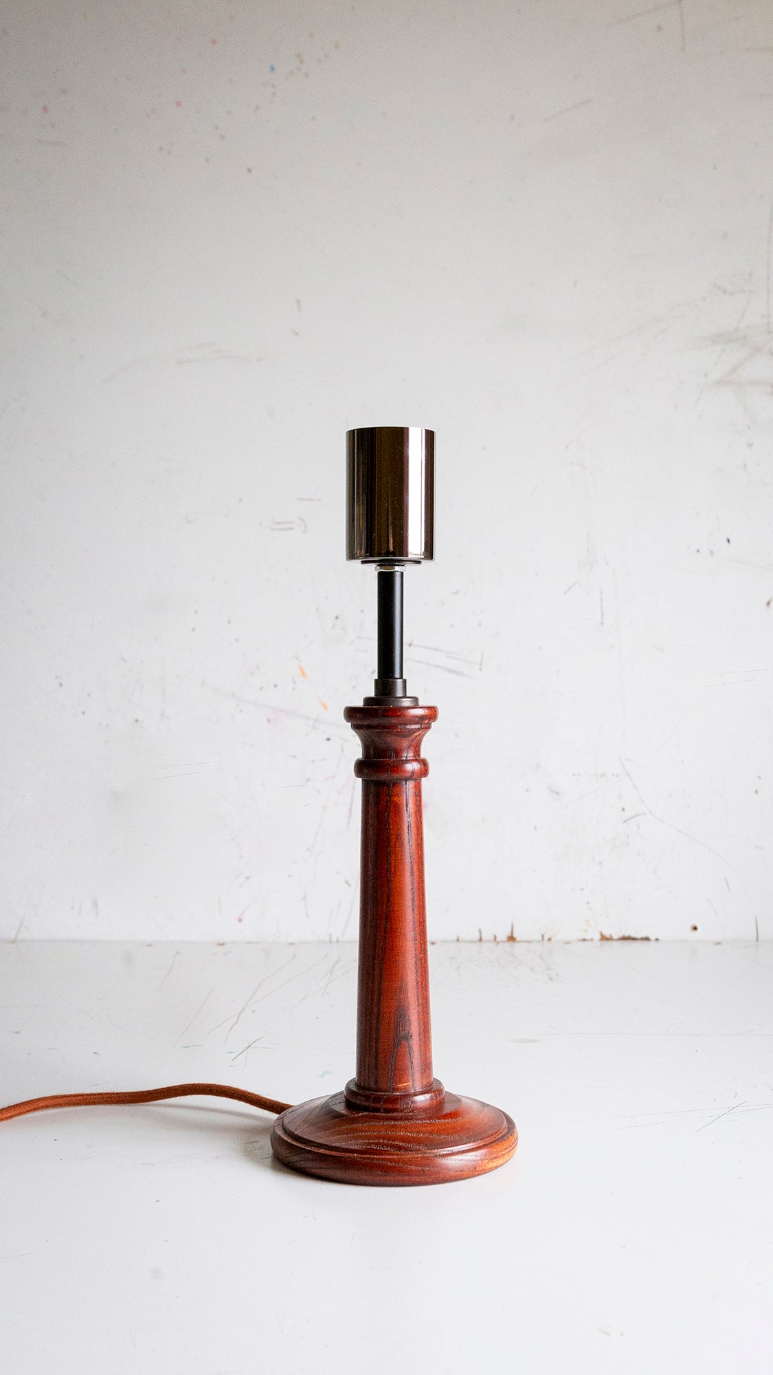 Wooden table lamp with a black pearl lamp holder on a white background