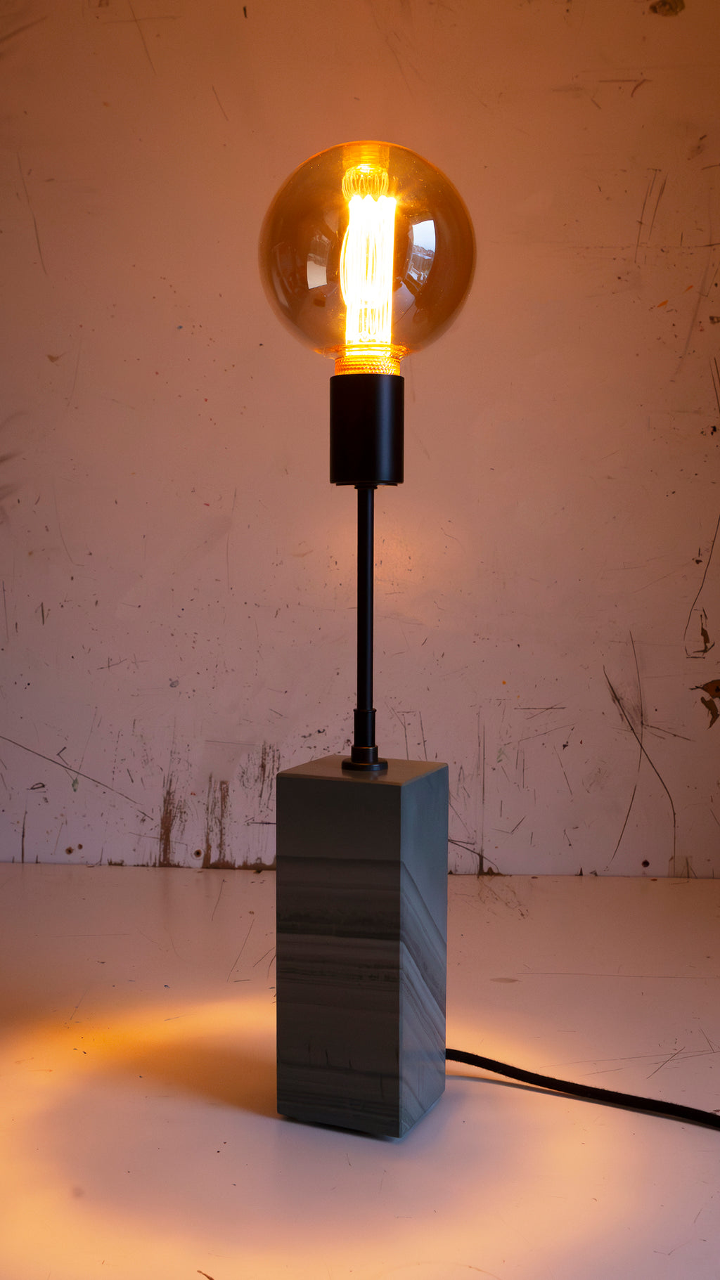 Gorgeously heavy solid slate / stone base reimagined with a 6 inch extension and matt black lamp holder & black cotton cable