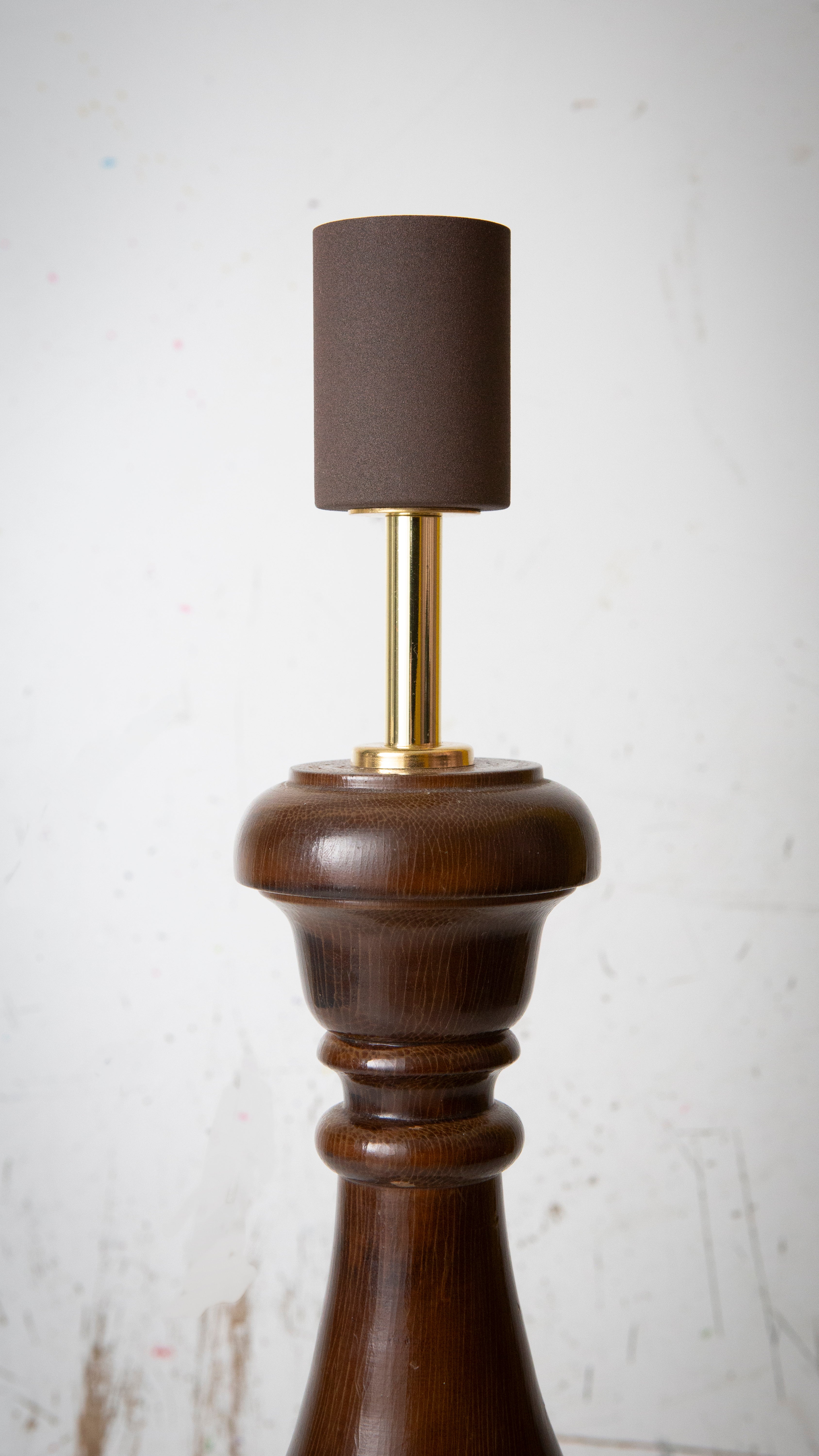 Lamp with wooden base and brown rusty coloured lamp holder on a white background