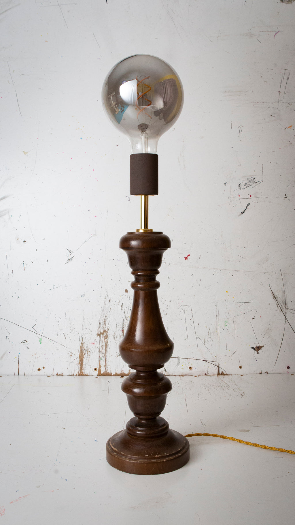 Vintage-style table lamp with wooden base and clear glass bulb on a white background