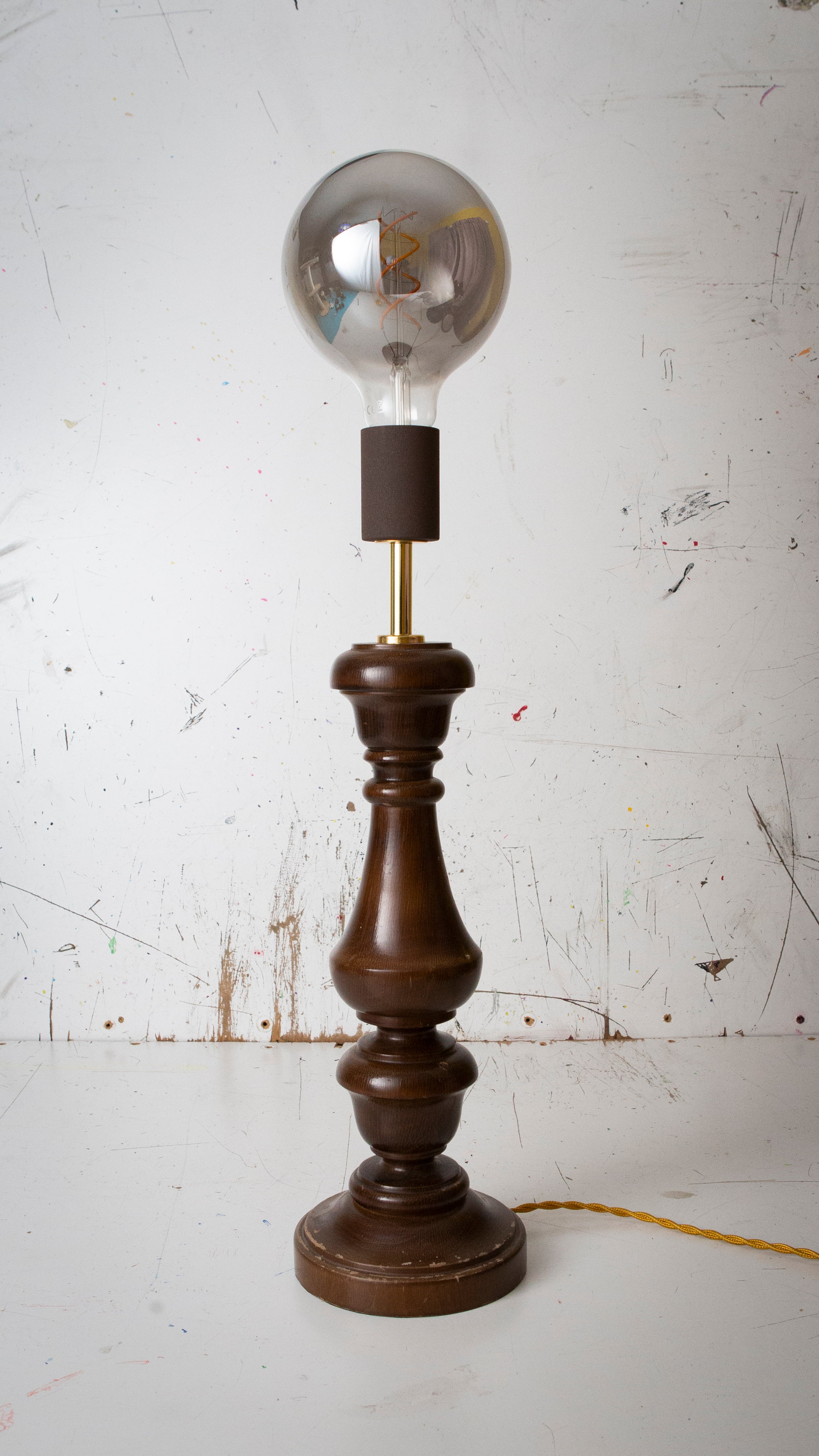 Vintage-style table lamp with wooden base and clear glass bulb on a white background