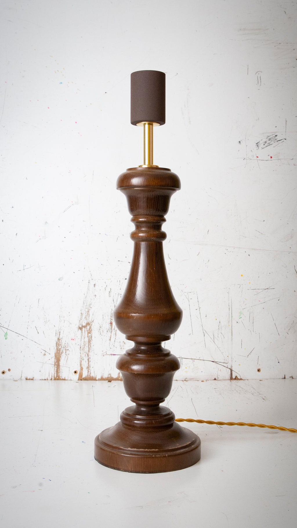 Wooden lamp with a dark brown base and rusty brown lamp holder on a white background