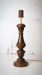 Wooden lamp with a dark brown base and rusty brown lamp holder on a white background