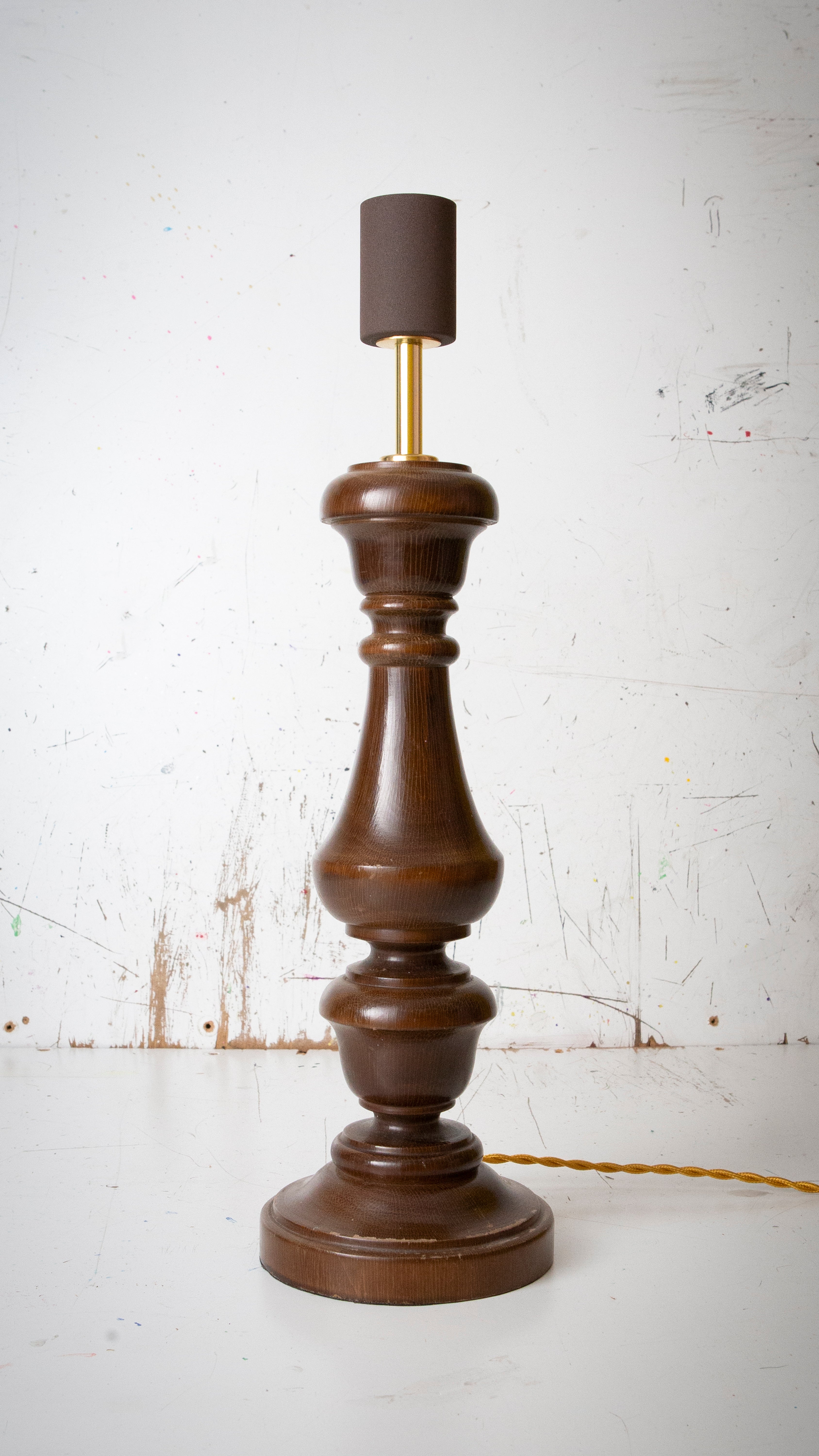 Wooden lamp with a dark brown base and rusty brown lamp holder on a white background